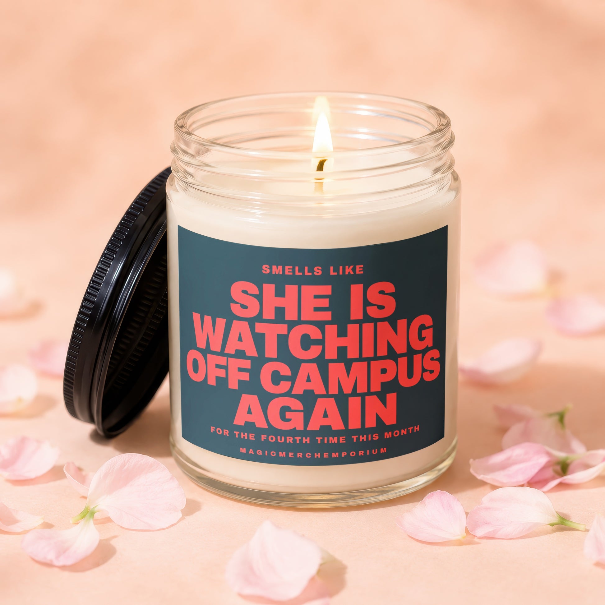 Scented candle with lid off, reading "She is watching off campus again".
