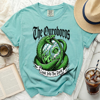 Aqua t-shirt with green ouroboros snake graphic and "The Ouroboros Look Into The Dark" text.