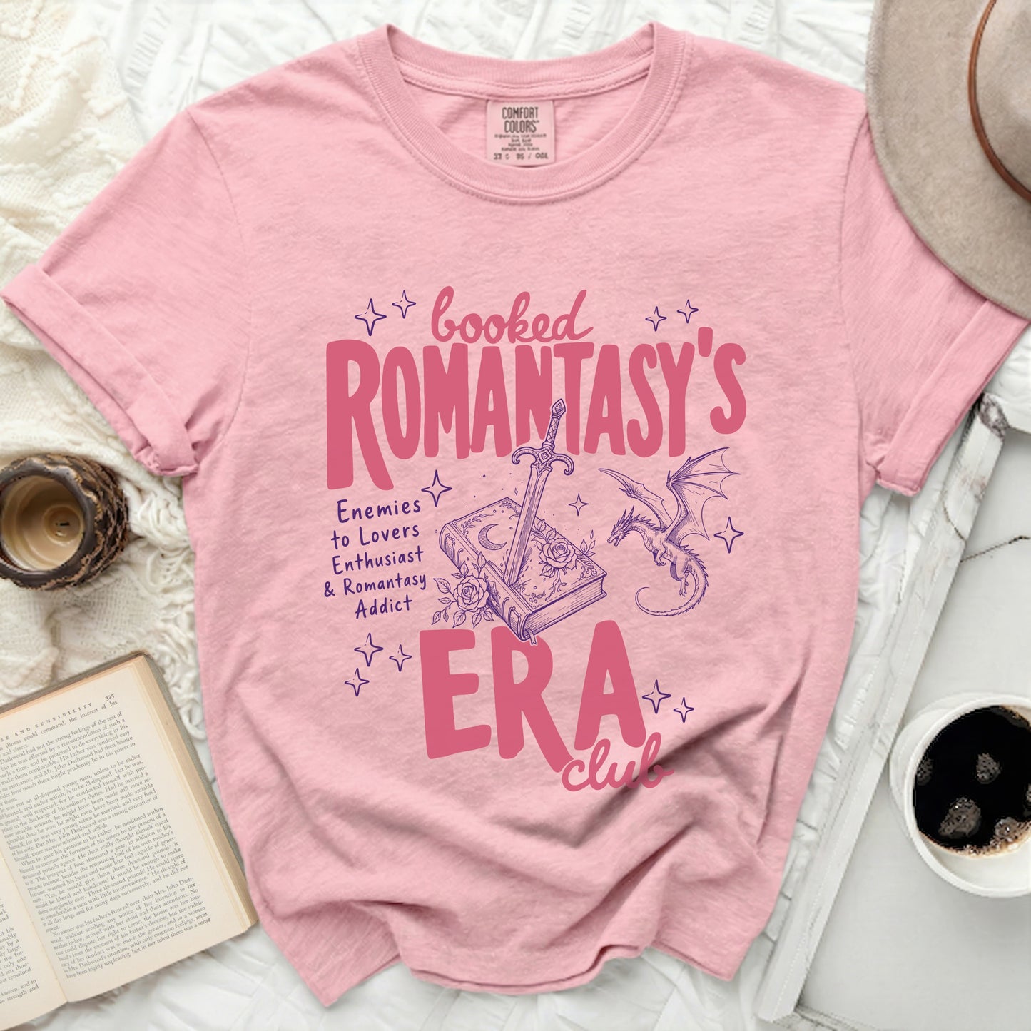 Pink t-shirt with "Booked Romantasy's ERA Club" text and graphics.