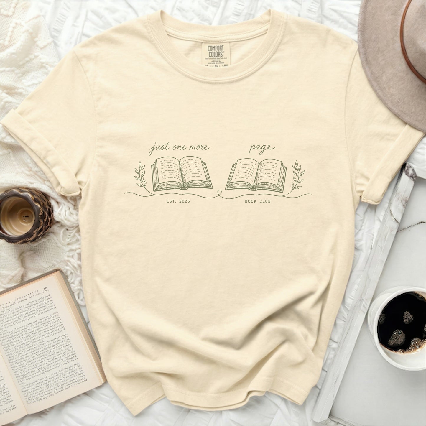 Cream t-shirt with "just one more page BOOK CLUB" and open book design.