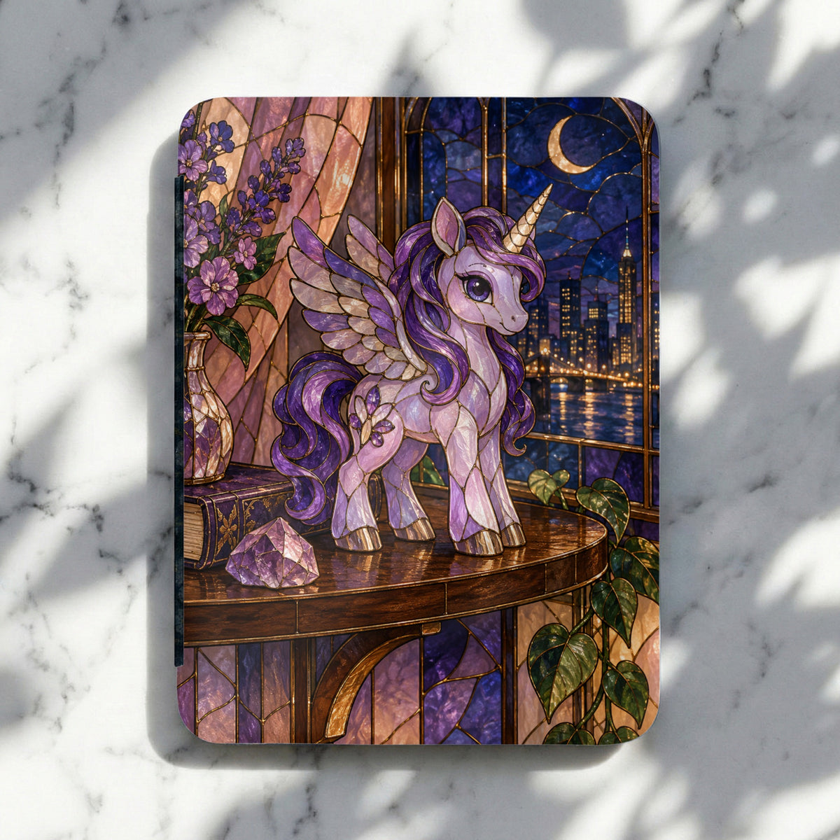 Stained glass unicorn with wings stands on a table by a city window at night.