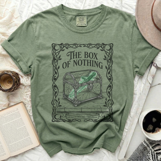 Green t-shirt featuring "The Box of Nothing" with a sword.