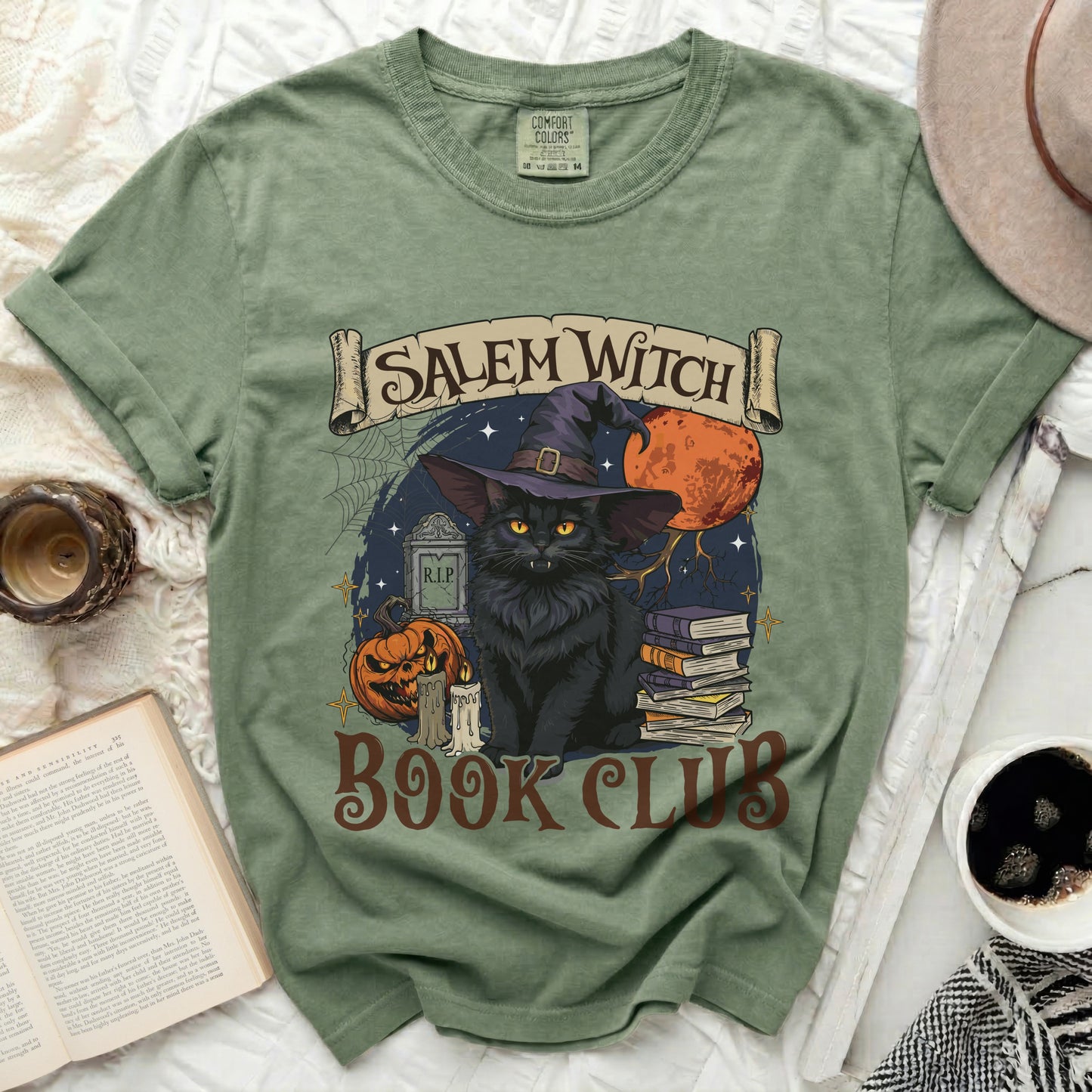 Green t-shirt with black cat, pumpkin, books, and "Salem Witch Book Club" text.