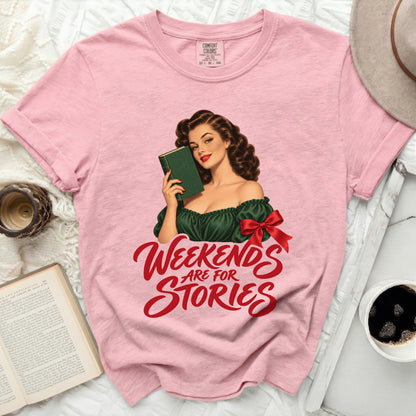 Pink t-shirt with "Weekends Are For Stories" graphic and vintage woman reading.