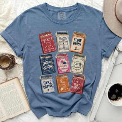 T-shirt with nine matchboxes featuring text like "Enemies to Lovers" and "Slow Burn."