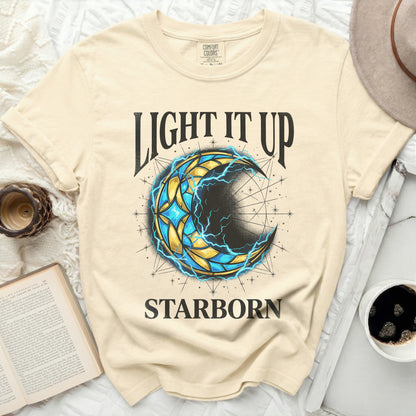 Cream t-shirt with "LIGHT IT UP STARBORN" and a crescent moon design.