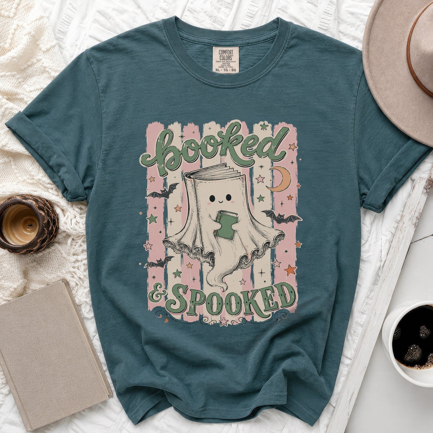 Teal t-shirt with "Booked & Spooked" text and a ghost holding a book.