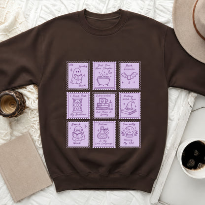 Brown sweatshirt with nine purple stamp designs featuring books and spooky reading themes.
