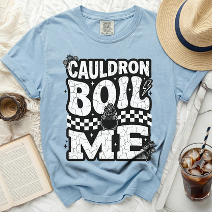 Light blue t-shirt with "Cauldron Boil Me" graphic featuring a cauldron.