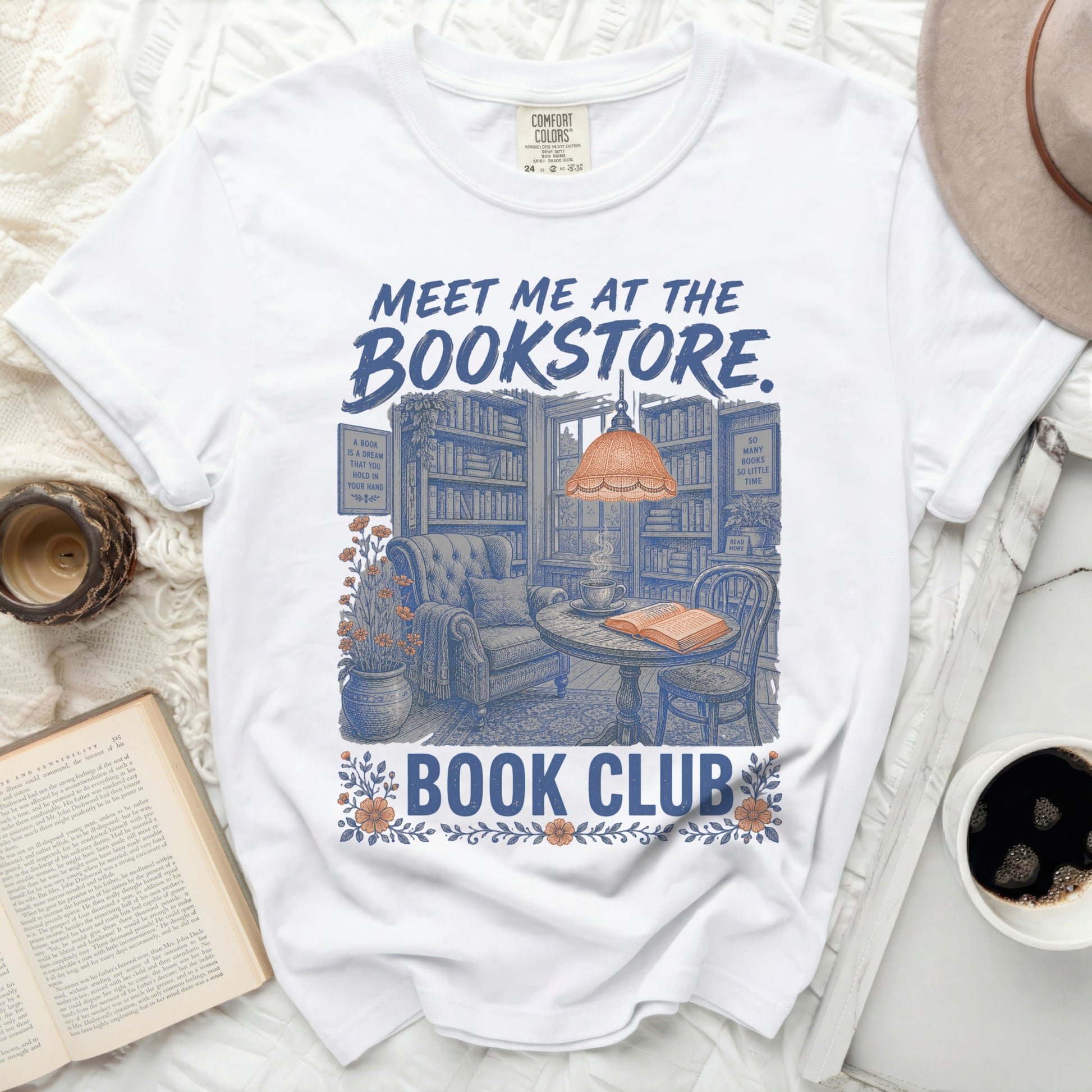 White t-shirt with "MEET ME AT THE BOOKSTORE. BOOK CLUB" text and bookstore illustration.