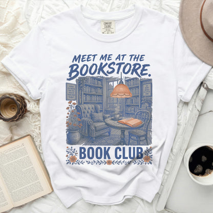 White t-shirt with "MEET ME AT THE BOOKSTORE. BOOK CLUB" text and bookstore illustration.