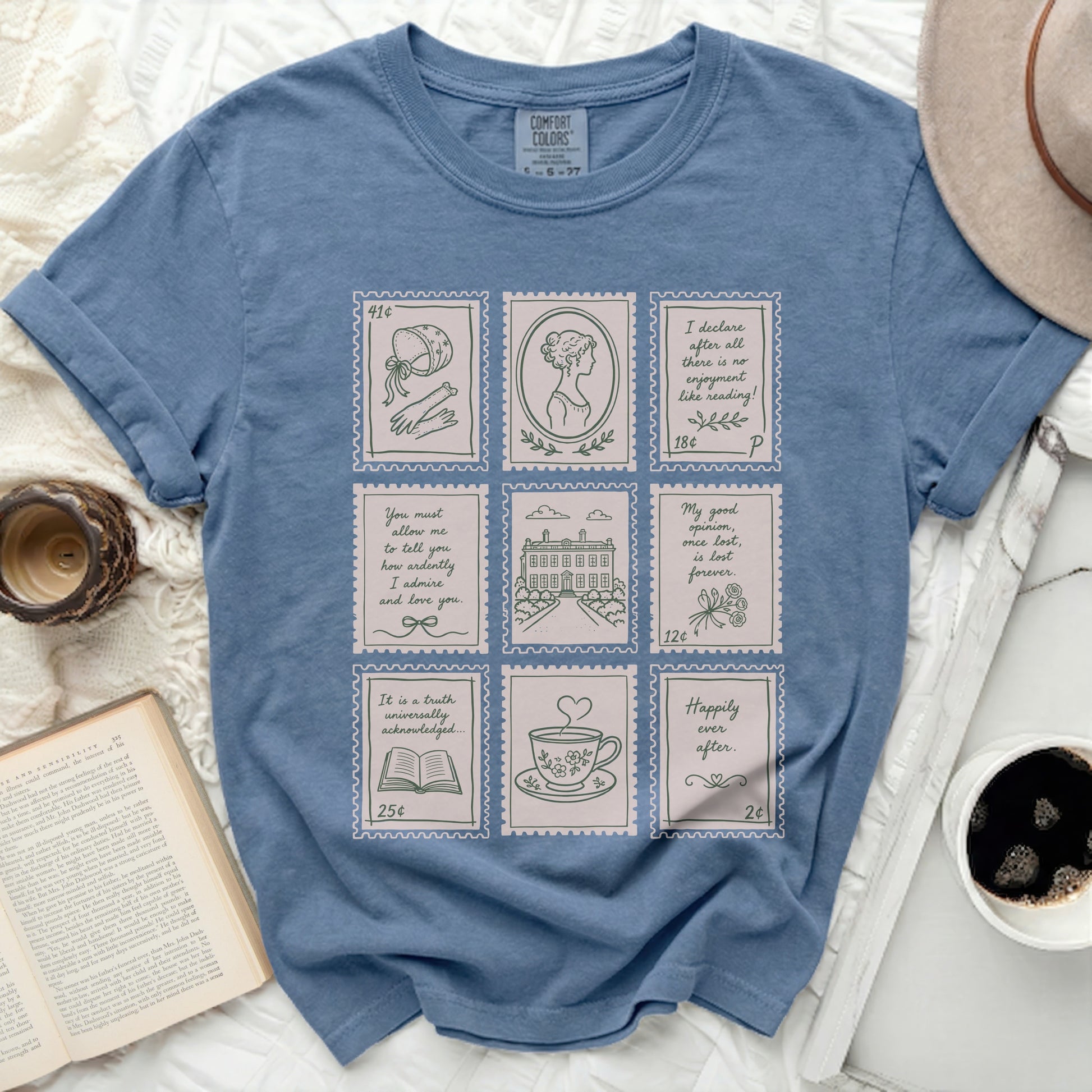 Blue t-shirt with nine postage stamp illustrations and snippets of text.