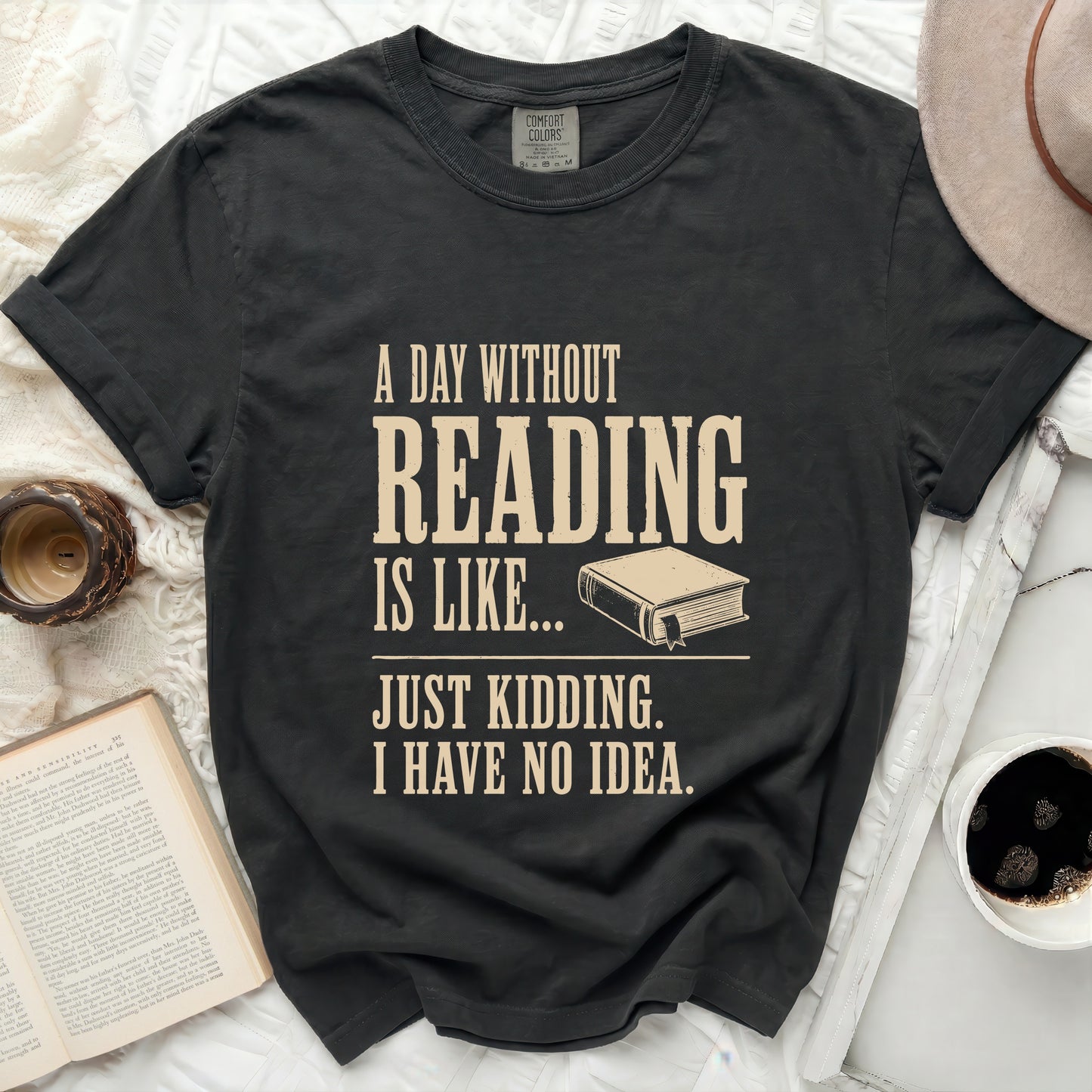 Black t-shirt with "A day without reading is like... Just kidding. I have no idea." text.