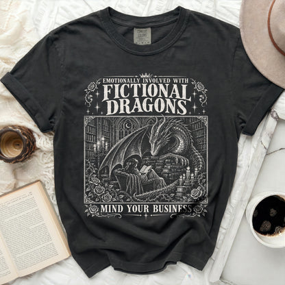 Embroidered black t-shirt with a fictional dragon reading to a girl.