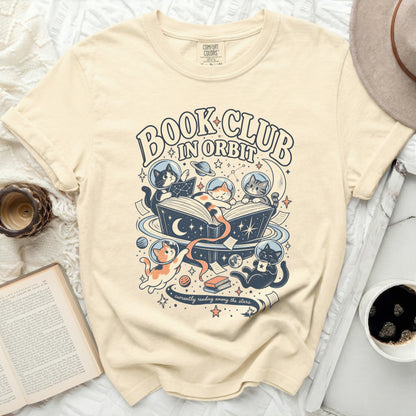 Cream t-shirt with "Book Club In Orbit" and cats in space reading.