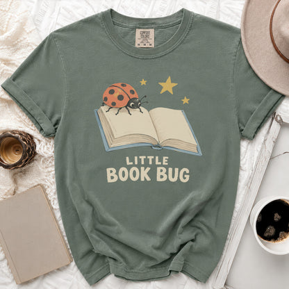 Green t-shirt with "LITTLE BOOK BUG" text and a ladybug on an open book.