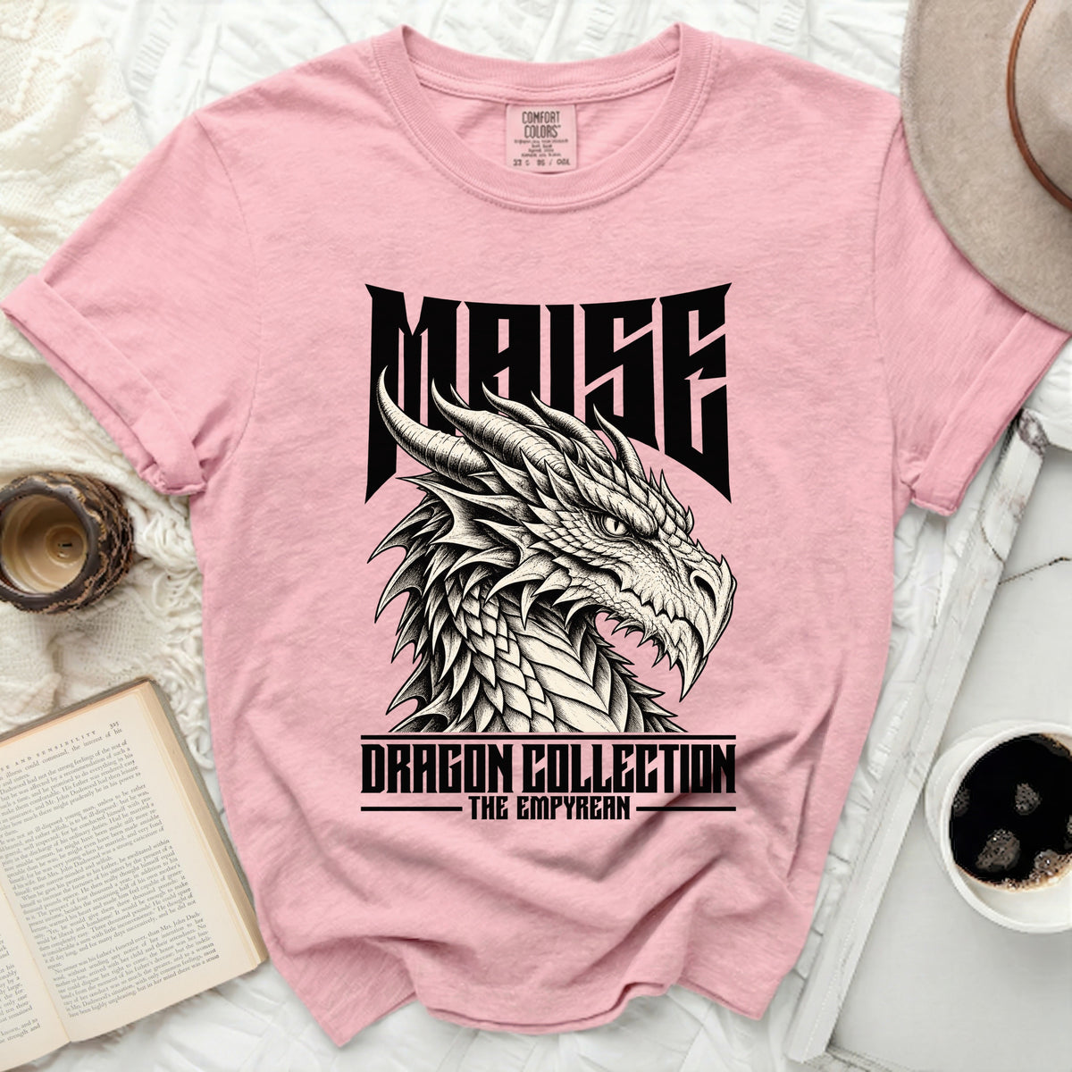 Pink t-shirt with a black dragon graphic and "MAISE DRAGON COLLECTION THE EMPYREAN" text.