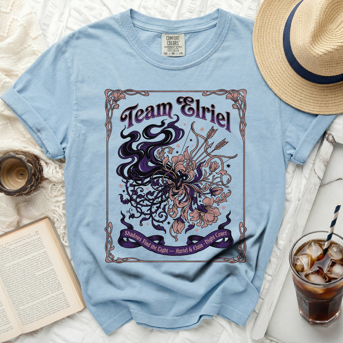 Light blue t-shirt with "Team Elriel" and floral, arrow graphic.