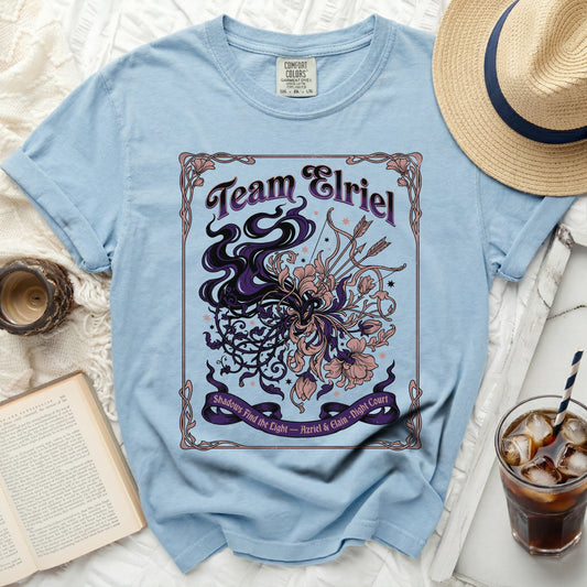 Light blue t-shirt with "Team Elriel" and floral, arrow graphic.