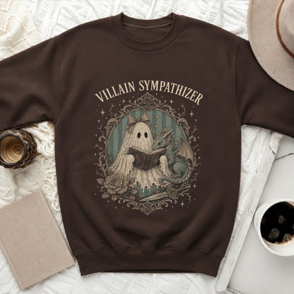 Brown sweatshirt with "Villain Sympathizer" text and ghost and dragon reading a book.