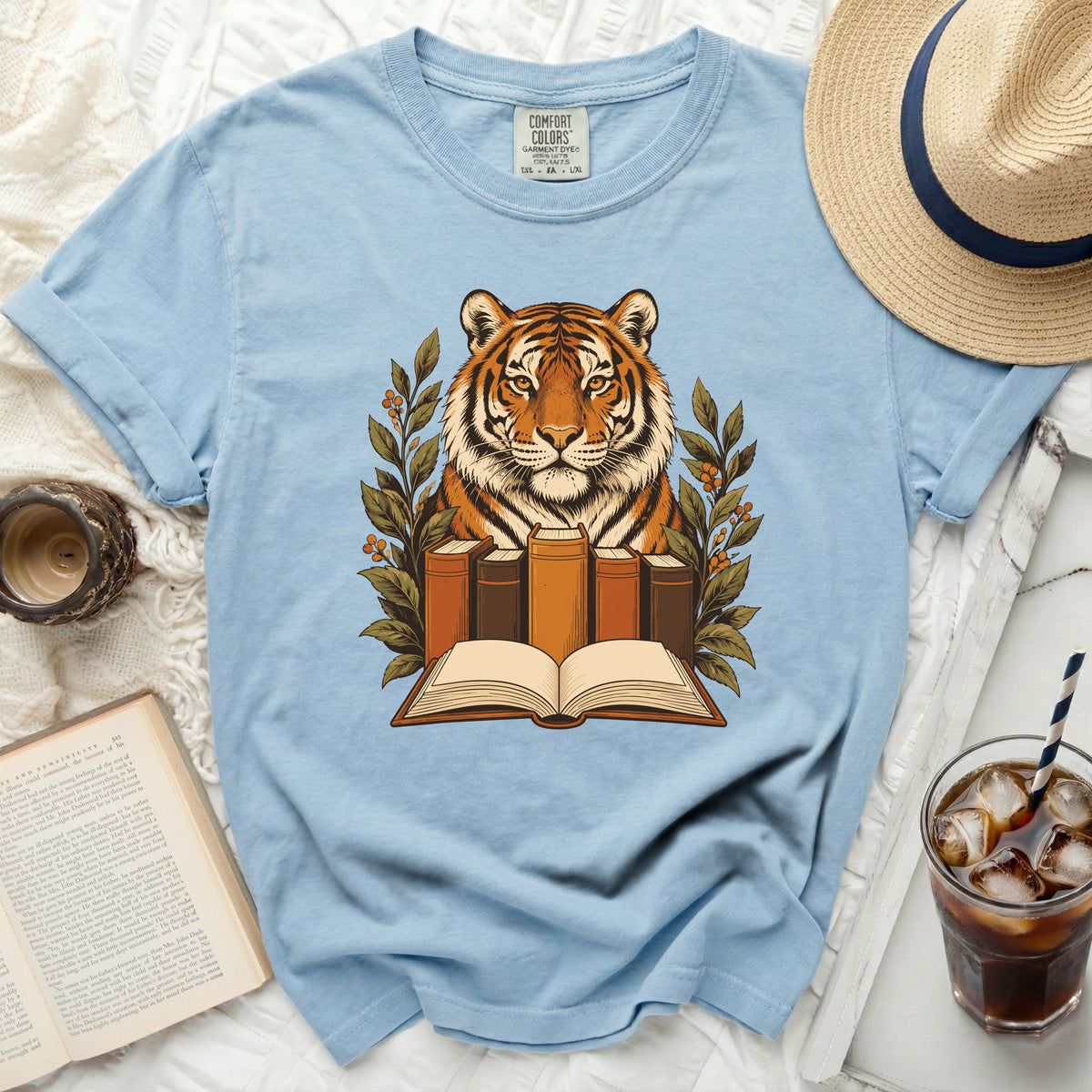 Blue t-shirt with tiger and book graphic, Comfort Colors tag visible.