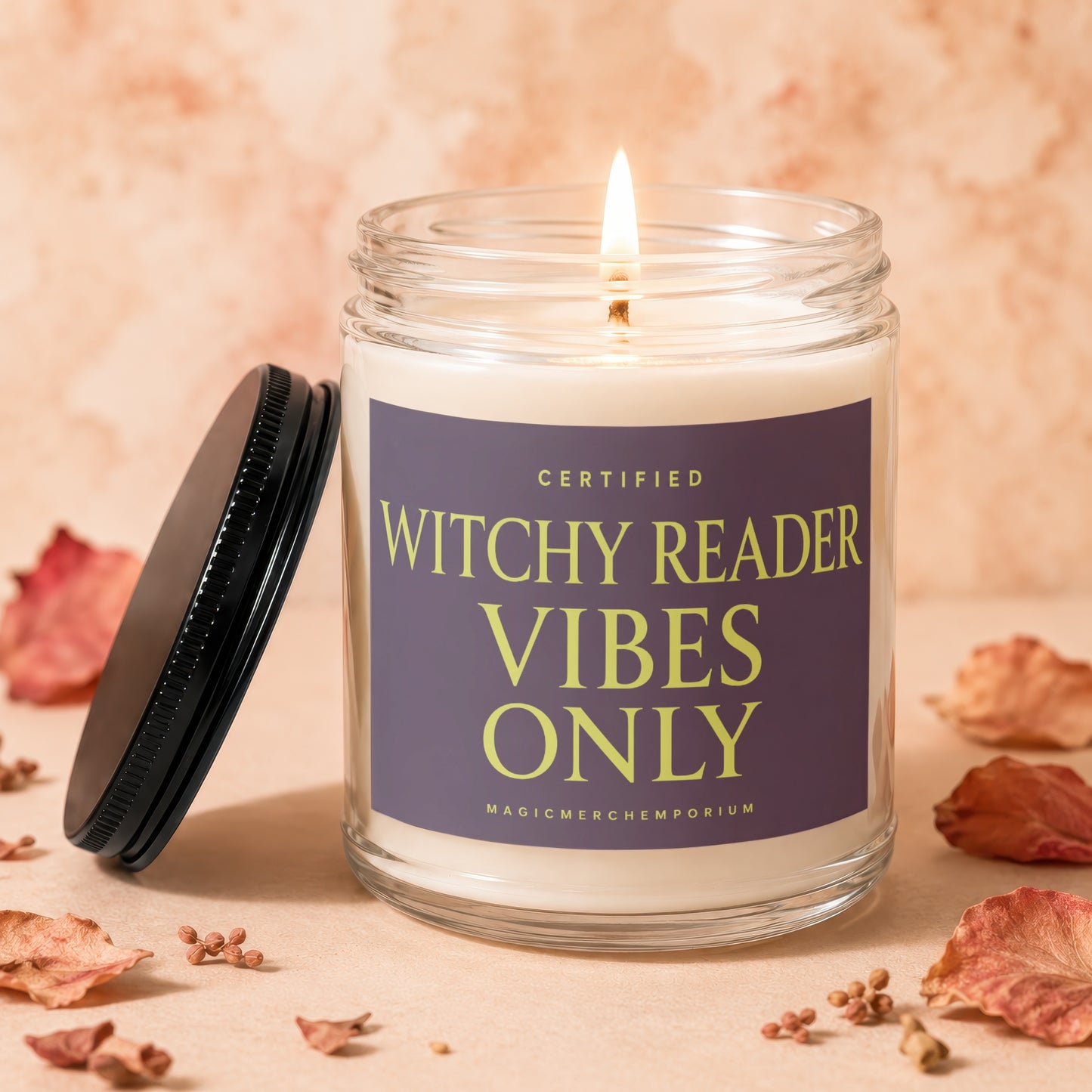Candle with "Certified Witchy Reader Vibes Only" text, lid beside it.