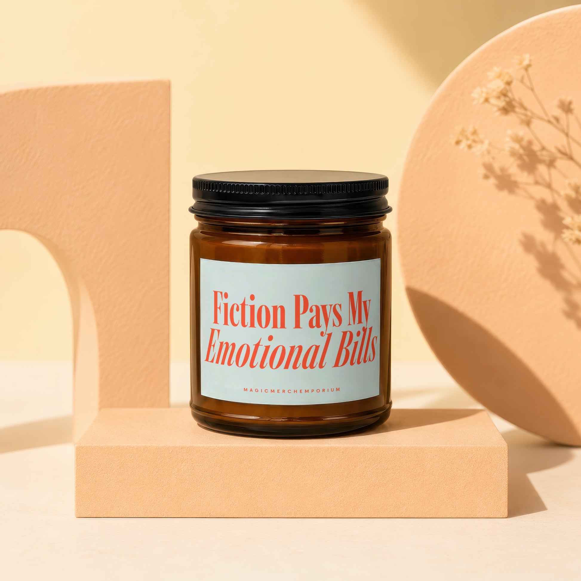 Amber jar candle with "Fiction Pays My Emotional Bills" text.