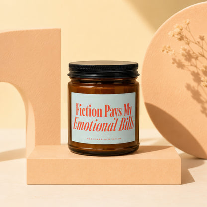 Amber jar candle with "Fiction Pays My Emotional Bills" text.