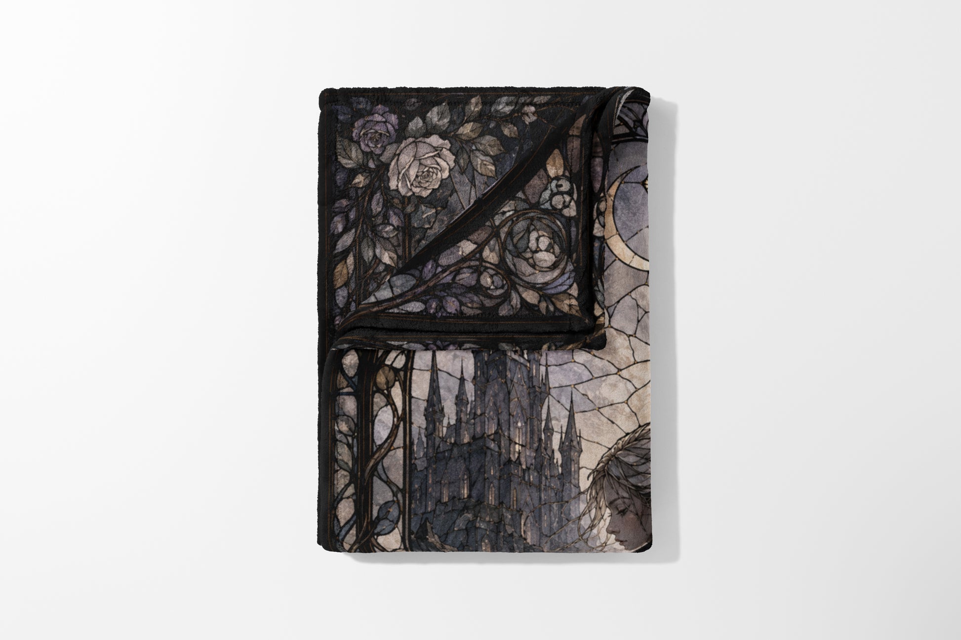 Folded blanket with stained glass design of roses, castle, and a woman.