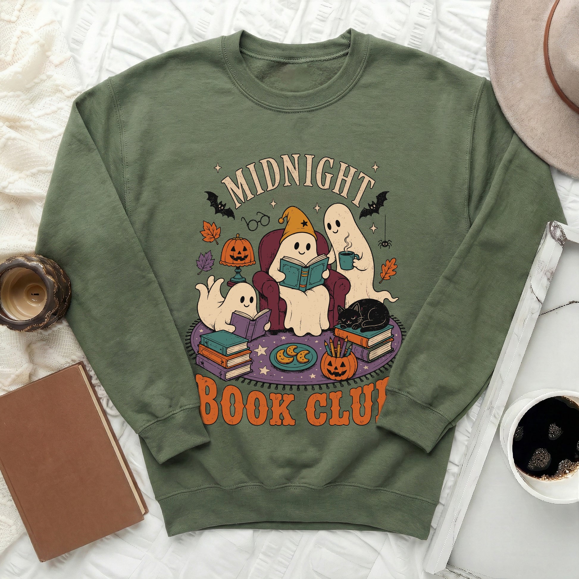 Green sweatshirt with "Midnight Book Club" text and ghost illustrations.