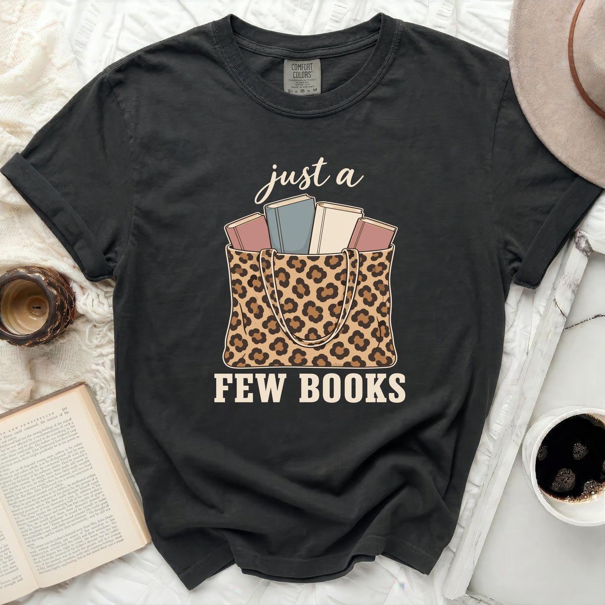 Black t-shirt with "just a few books" and leopard print tote bag graphic.