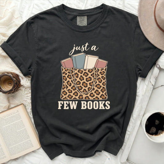 Black t-shirt with "just a few books" and leopard print tote bag graphic.