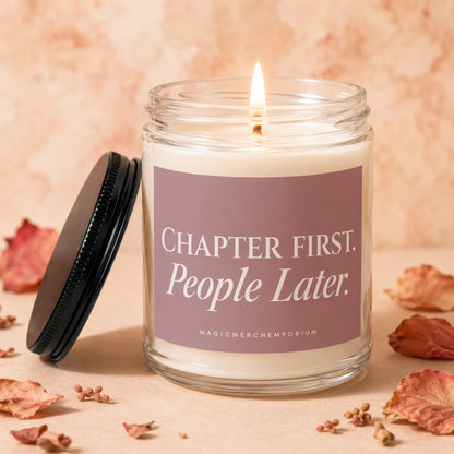 Candle with "Chapter First. People Later." text, lit wick, and black lid.