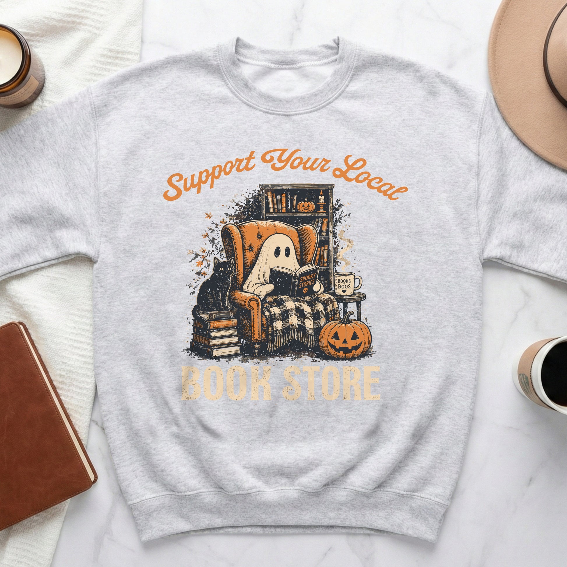 Ghost reading by a fireplace with a cat saying "Support Your Local Book Store".
