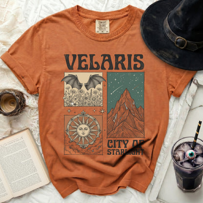 Orange t-shirt with "Velaris City of Starlight" graphic and celestial designs.
