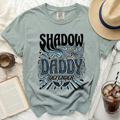 Shadow Daddy Defender graphic tee with wavy blue and black design.