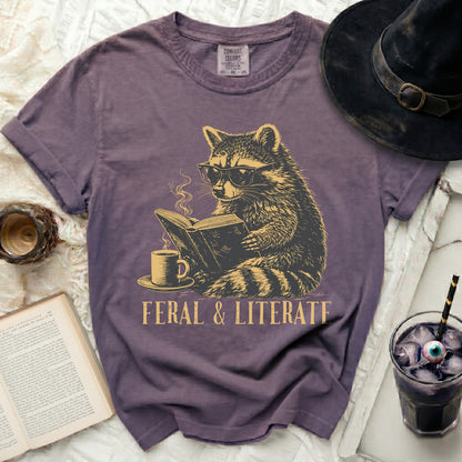T-shirt with raccoon reading a book and text "FERAL & LITERATE".