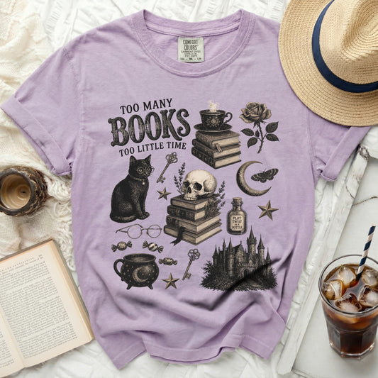 Lavender t-shirt with "Too Many Books Too Little Time" graphic art.