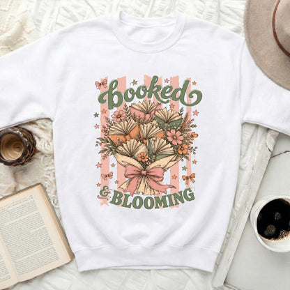 Graphic of books and flowers with text "booked & blooming"