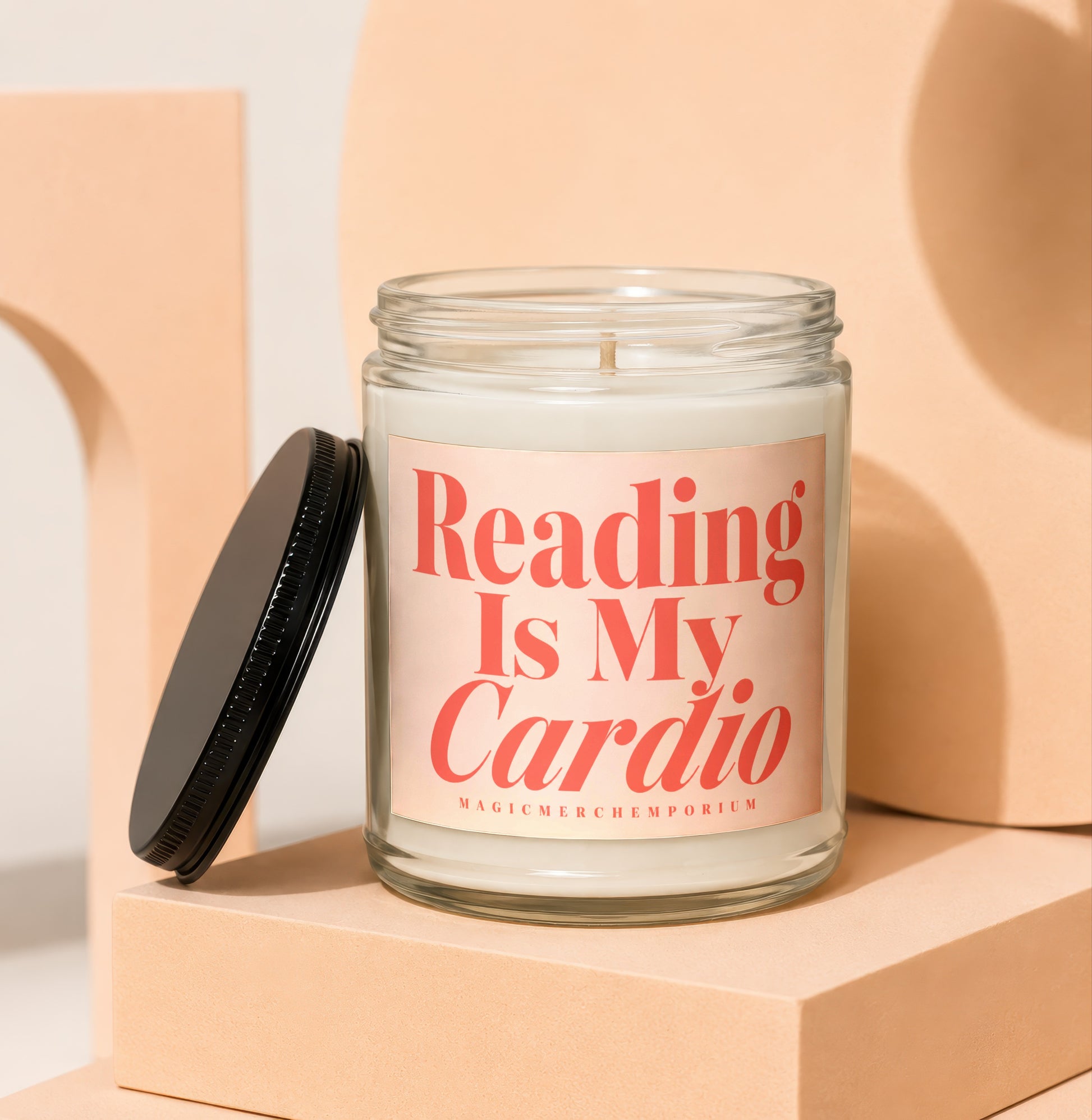 Glass candle with pink label that reads "Reading Is My Cardio".