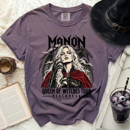 Purple t-shirt with "MANON QUEEN OF WITCHES TOUR BLACKBEAK THE THIRTEEN" graphic.