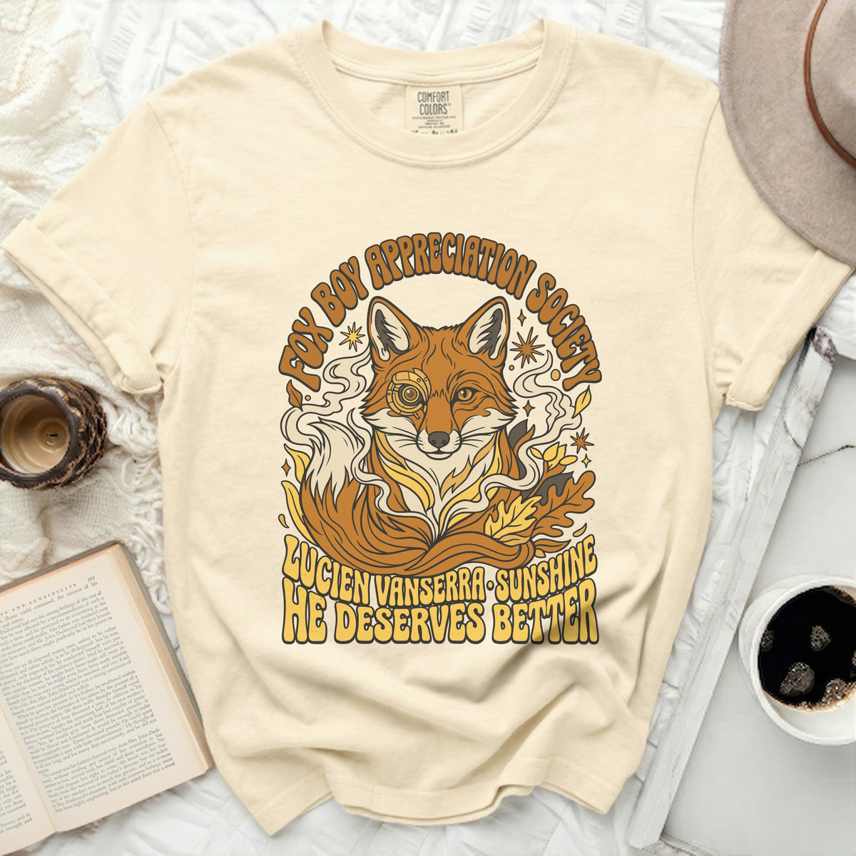 Cream t-shirt with a graphic of a fox and text "Fox Boy Appreciation Society" and "Lucien Vanserra Sunshine He Deserves Better."
