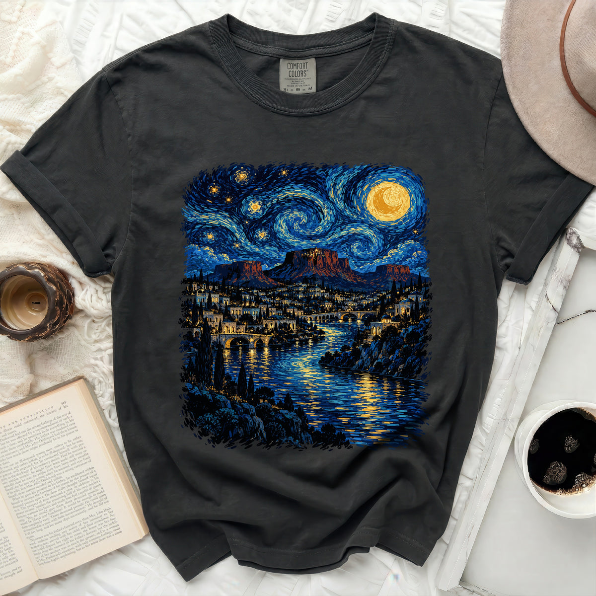 Dark t-shirt with a stylized night sky and city landscape print.