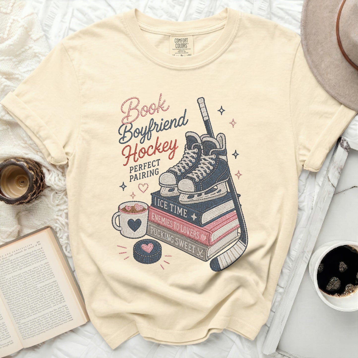 Cream t-shirt with "Book Boyfriend Hockey" design featuring skates, puck, and coffee.