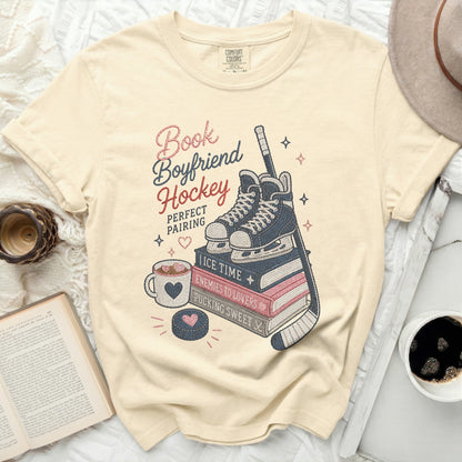 Cream t-shirt with "Book Boyfriend Hockey" design featuring skates, puck, and coffee.