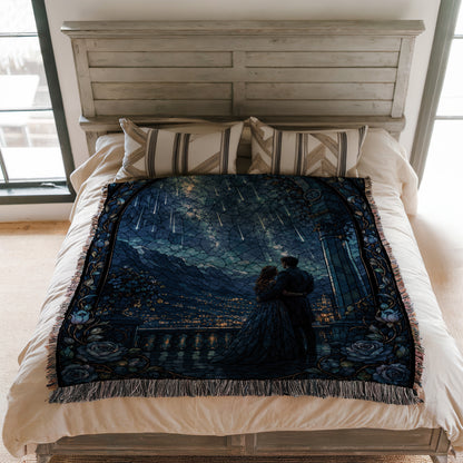 a bed with a decorative blanket featuring a painting of a couple standing together under a starry night sky.
