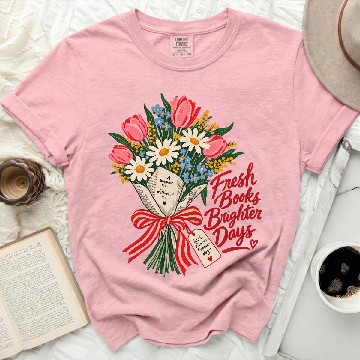 Pink t-shirt with bouquet of tulips, daisies, and forget-me-nots. Text reads "Fresh Books Brighter Days".