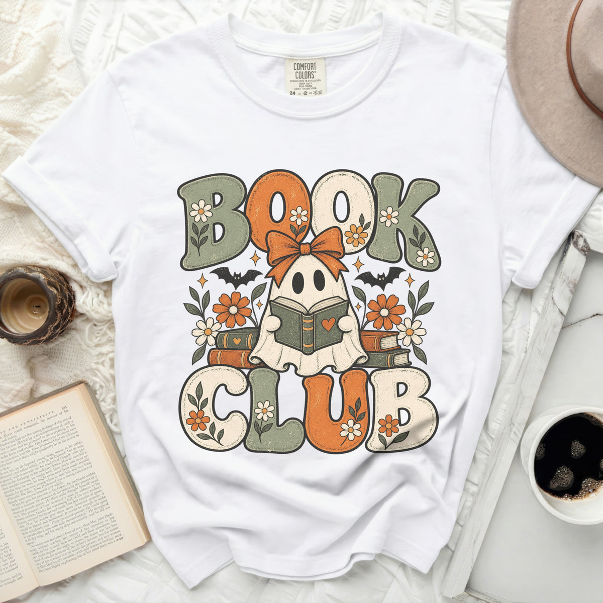 White t-shirt with "Book Club" ghost, bats, and flowers graphic.