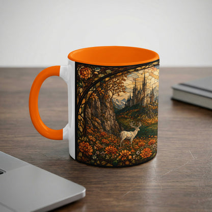 White mug with orange handle featuring a stained-glass design of a castle and stag.