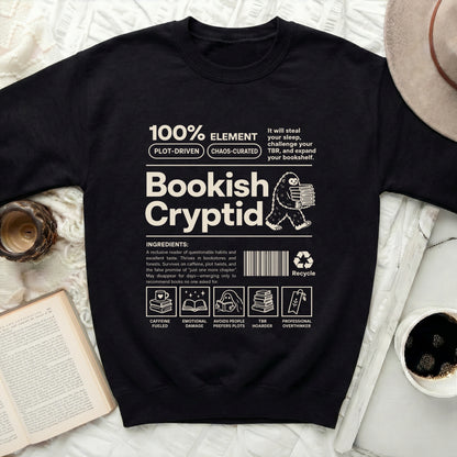 Bookish Cryptid crewneck sweatshirt with graphic of Bigfoot holding books and reading-themed ingredients.